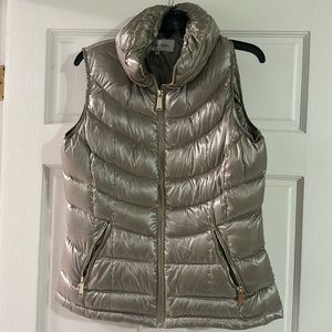 Puffy champagne vest with gold zip front and pockets
